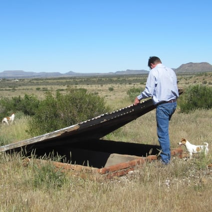 Simon Roche opens his ‘grave’, which is stocked full of emergency supplies, on a farm in the Northern Cape. Photo by Kate Bartlett
