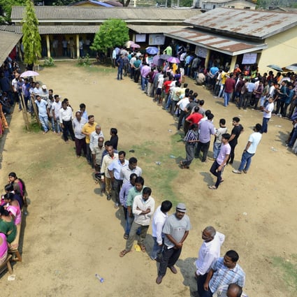 Voters queue at a polling station in Guwahati, Assam, on April 23. Photo: EPA