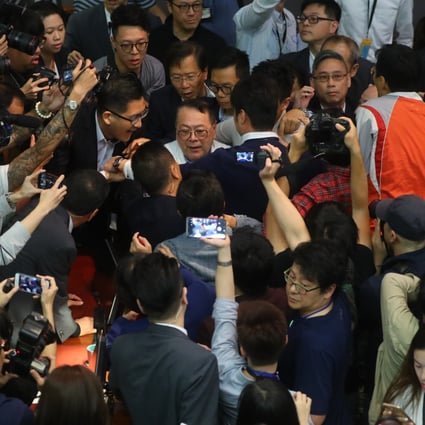 Legislator Abraham Razack is surrounded by lawmakers and the media in chaotic scenes inside the Legislative Council. Photo: Edmond So