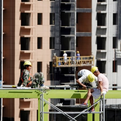 Beijing has considered a property tax for more than 10 years, although progress on draft legislation has run into opposition from stakeholders. Workers at a construction site of residential buildings in Zhengzhou, Henan province. Photo: Reuters
