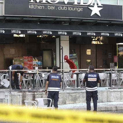 Forensic personnel inspect the site of a grenade attack at a bar and restaurant in Puchong, outside Kuala Lumpur, in 2016. Photo: AP