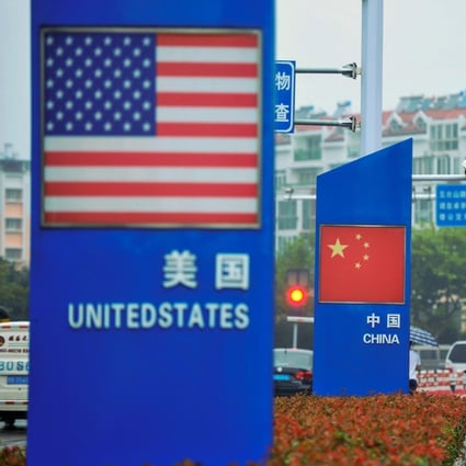 Signs with the US flag and Chinese flag are seen outside a store selling foreign goods in Qingdao in China's eastern Shandong province on September 19, 2018. – China on September 18 announced tariffs on US goods worth $60 billion in retaliation for President Donald Trump's decision to slap duties on $200 billion in Chinese products next week. Photo: Agence France-Presse