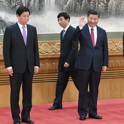 Chinese President Xi Jinping waves to reporters from the podium with members of his leadership team including Premier Li Keqiang, Li Zhanshu, and Wang Huning at the Great Hall of the People in Beijing. Photo: Kyodo