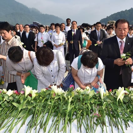 Followers of the Unification Church lay flowers in tribute to Reverend Sun Myung Moon. Photo: AFP