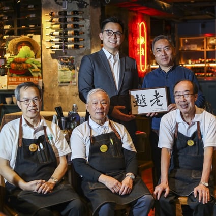 Back row left to right: General manager Kenneth Choi and senior operation manager Glenn Chang with some of their employees at the Gingko House Restaurant in Yau Ma Tei. Photo: Winson Wong