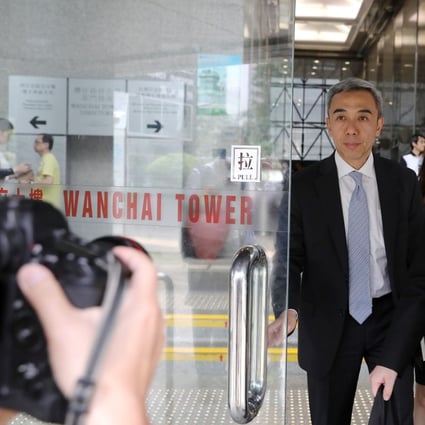 Wilson Fung Wing-yip (left), the former deputy secretary for economic development and labour, arrives at the District Court in Wan Chai on Monday. Photo: K.Y. Cheng