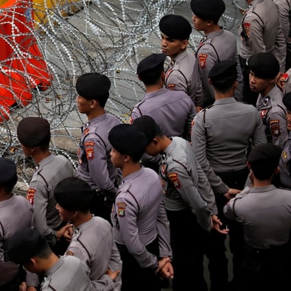 Indonesian police officers stand guard during a May Day rally near the National Monument (Monas) in Jakarta. Photo: Reuters