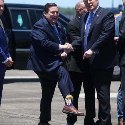 US President Donald Trump is greeted by Louisiana Lieutenant Governor Billy Nungesser showing off his socks as the president arrives in Lake Charles, Louisiana, May 14, 2019. Photo: Reuters