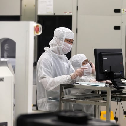 Workers dressed in dust-proof clothing at the 12-inch wafer plant of Semiconductor Manufacturing International Corporation (SMIC) in Beijing on 27 August 2012. Photo: Handout