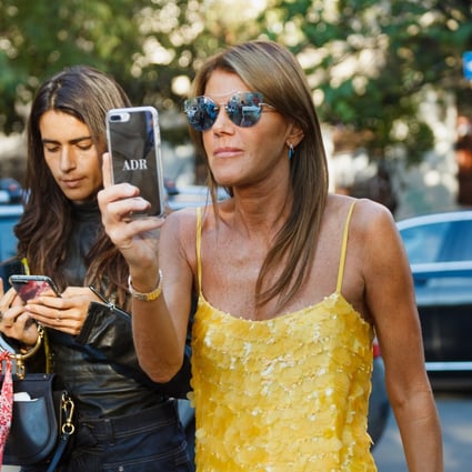 Vogue Japan’s Anna Dello Russo with her personalised phone case at Milan Fashion Week. Photo: Shutterstock
