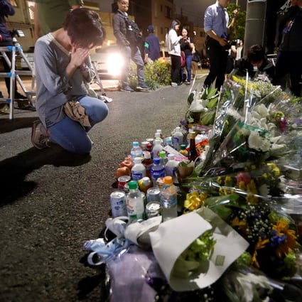 A local resident prays to mourn victims of Tuesday’s mass stabbing in Kawasaki, Japan. Photo: Reuters