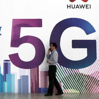 A man talks on his smartphone beside Huawei's billboard featuring 5G technology at the PT Expo in Beijing, China, September 26, 2018. Photo: Reuters
