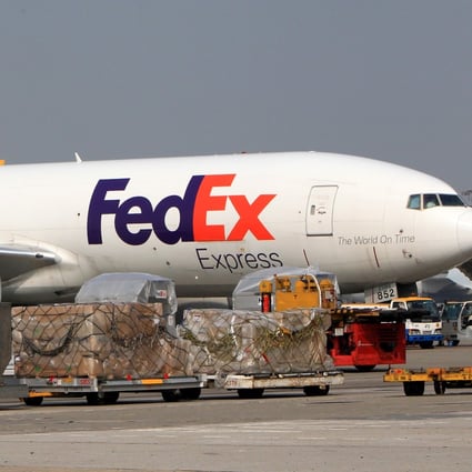 A FedEx cargo aircraft is seen parked at a gate near the FedEx facility at the Hong Kong International Airport. Photo: Jonathan Wong