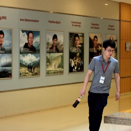 A man walks past a board showing Huawei University's motto in a training centre at Huawei headquarters in Shenzhen on Friday. Photo: Reuters