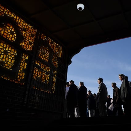 Worshippers leave a mosque in Kashgar after prayers on Wednesday. Photo: AFP