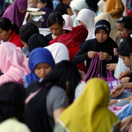 Indonesian domestic workers in Hong Kong's Victoria Park. Officials from the country have mooted a policy that would stop women working overseas as maids. Photo: AFP