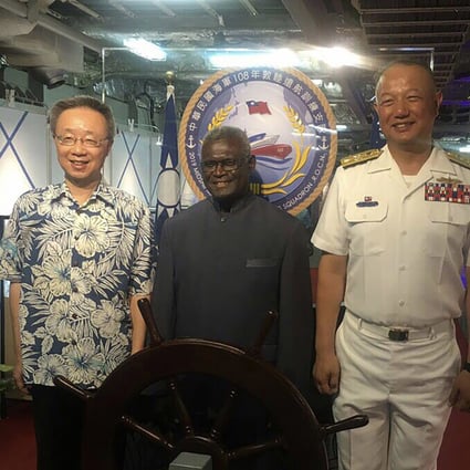 Manasseh Sogavare, prime minister of Solomon Islands (centre), joins Taiwan’s ambassador to the Pacific nation Roger Luo (left) and Commander Rear-Admiral Wang Cheng-chung aboard a Taiwanese naval vessel. Photo: CNA