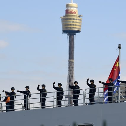 Chinese sailors wave from a PLA Navy ship after it arrives at Garden Island Naval Base in Sydney. Photo: EPA