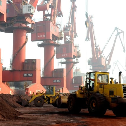 Workers transport soil containing rare earth elements for export at a port in Lianyungang in Jiangsu province on October 31, 2010. Photo: Reuters