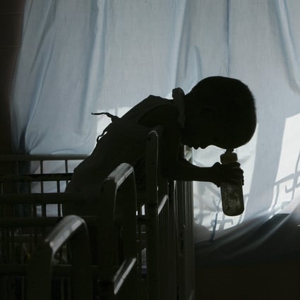 A five-year-old disabled victim of Agent Orange rests on his cot in a Ho Chi Minh City hospital in 2005. Photo: Reuters