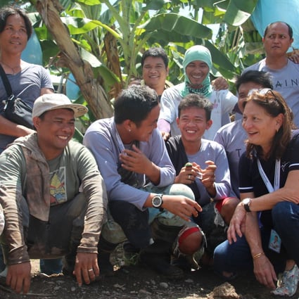 Rosanna Tuason-Fores, CEO and president (extreme right), sits for a chat with farmers.