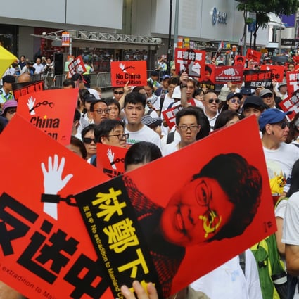 Protesters carry anti-Carrie Lam signs at Sunday’s demonstration. Photo: Edmond So