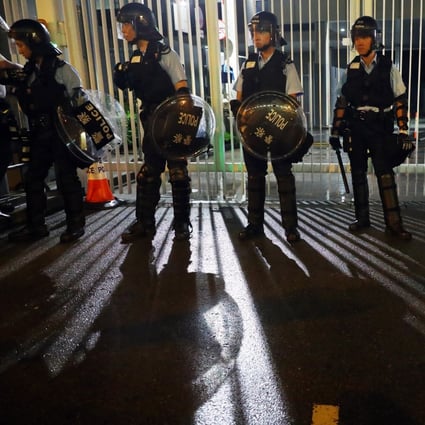 Police officers surround the legislature in the early hours of Wednesday. Photo: Edmond So