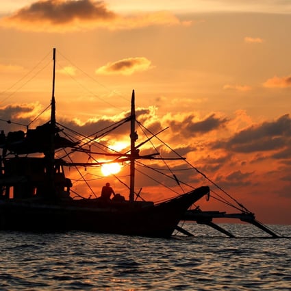A Philippine boat fishes during sunset at the disputed Scarborough Shoal in April 2017. Photo: Reuters
