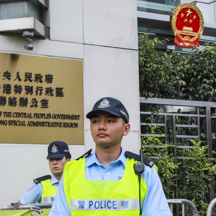 Two police officers stand guard outside The Liaison Office of the Central People's Government in the HKSAR in Sai Wan. Photo: May Tse