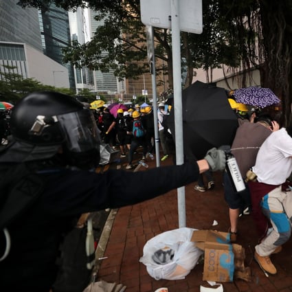 Officers and protesters clash during demonstrations against Hong Kong’s controversial extradition legislation, with police now rolling back on the use of the term ‘riot’. Photo: Sam Tsang