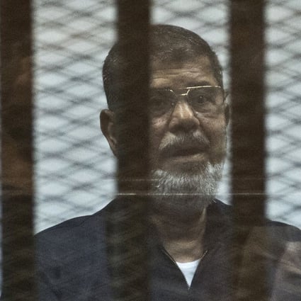 Egypt's ousted president Mohammed Mursi behind bars during a trial in 2015. File photo: AFP
