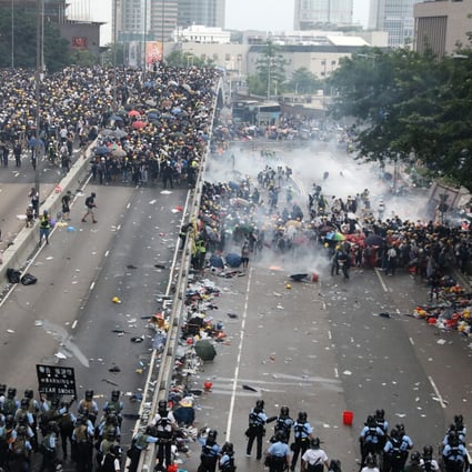 Riot police fire tear gas and push anti-extradition bill protesters away from the Legislative Council Complex along Harcourt Road last Wednesday. Photo: K.Y. Cheng