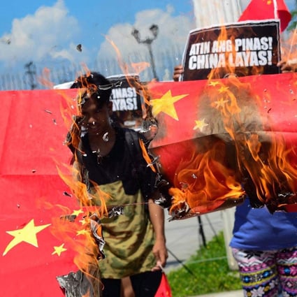 Protesters in Manila burn Chinese flags made of paper. Photo: Handout