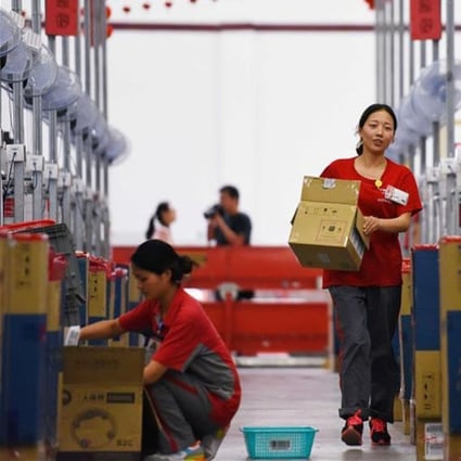 Workers at a JD.com distribution centre process goods set for delivery during the 618 shopping festival. Photo: Xinhua