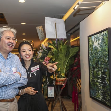 Sharon Cheung with former Hong Kong financial secretary John Tsang at her solo art exhibition in Tsim Sha Tsui. Photo: Xiaomei Chen