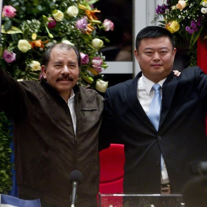 Nicaraguan President Daniel Ortega and Chinese businessman Wang Jing hold up a concession agreement for the construction of the Nicaragua Canal. Photo: AP