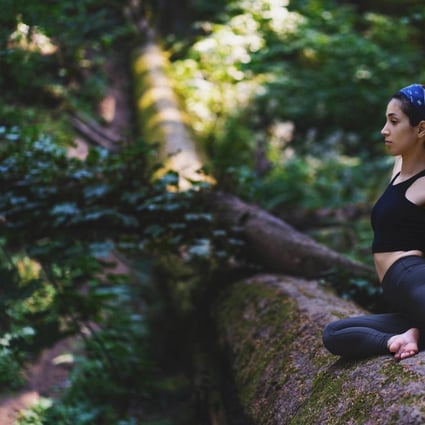 A woman does yoga during the Ayus Wellness Experience, in Gunung Mulu National Park, a Unesco World Heritage Site in Malaysian Borneo. Photo: Ayus Wellness