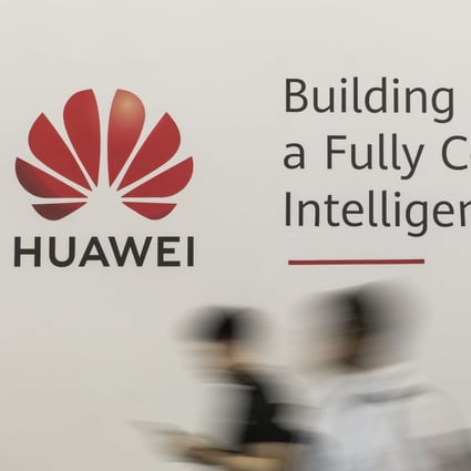 Attendees walk past a sign for Huawei Technologies at the MWC Shanghai 2019 trade show on June 27. Photo: Bloomberg