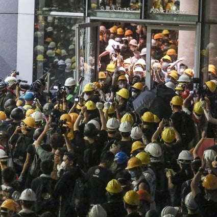 Protesters enter the Legislative Council building during a protest against the extradition bill on Monday. Photo: Dickson Lee