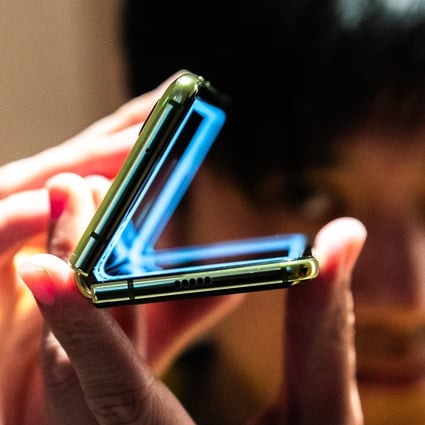 An attendee holds Samsung Electronics’ Galaxy Fold smartphone during an unveiling event in New York on April 15, 2019. Photo: Bloomberg