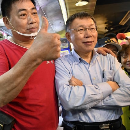 Taipei mayor Ko Wen-je poses for pictures with supporters on the campaign trail last November. Photo: AFP