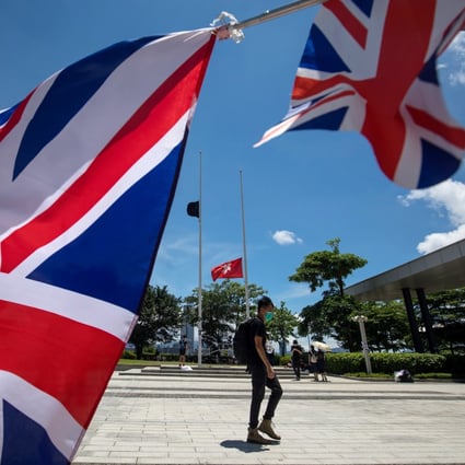 The British national flag flies in the foreground during a protest on July 1, as Hong Kong, a former British colony, marks the 22nd anniversary of its return to Chinese sovereignty. Photo: Bloomberg