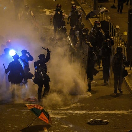 Police fire tear gas at protesters near the government headquarters in Hong Kong early on Tuesday. Photo: AFP