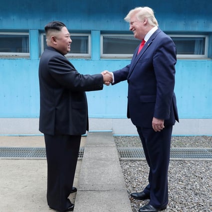 North Korean leader Kim Jong-un shakes hands with US President Donald Trump as they meet at the demilitarised zone separating the two Koreas on June 30. Photo: KCNA via Reuters