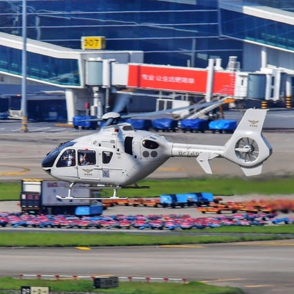 A helicopter departing on the first cross-border flight takes off for Hong Kong at Baoan International Airport in Shenzhen. Photo: Xinhua
