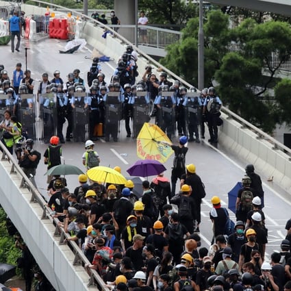 Police and protesters square off on a flyover in Admiralty on the morning of July 1. Photo: K.Y. Cheng