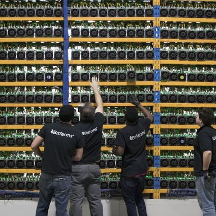 Employees check fans on mining machines at the Bitfarms cryptocurrency farming facility in Farnham, Quebec, Canada. Photo: Bloomberg