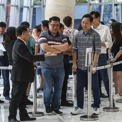 Prospective buyers wait for their turn to buy one of 229 units at Wing Tai Properties’ Oma Pma development in Tuen Mun, on June 30, 2019. The developer is putting on sale another lot of flats at the same project on Saturday. Photo: Jonathan Wong