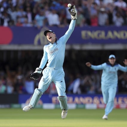 England’s Jos Buttler celebrates after running out New Zealand’s Martin Guptill, right, with the last ball of the last over of the Cricket World Cup final. Photo: AP