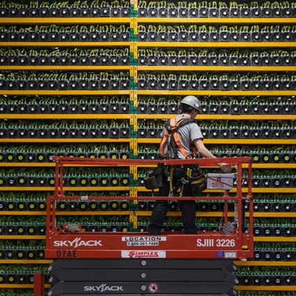 A technician inspects bitcoin mining systems at Bitfarms in Saint Hyacinthe, Quebec. File photo: AFP
